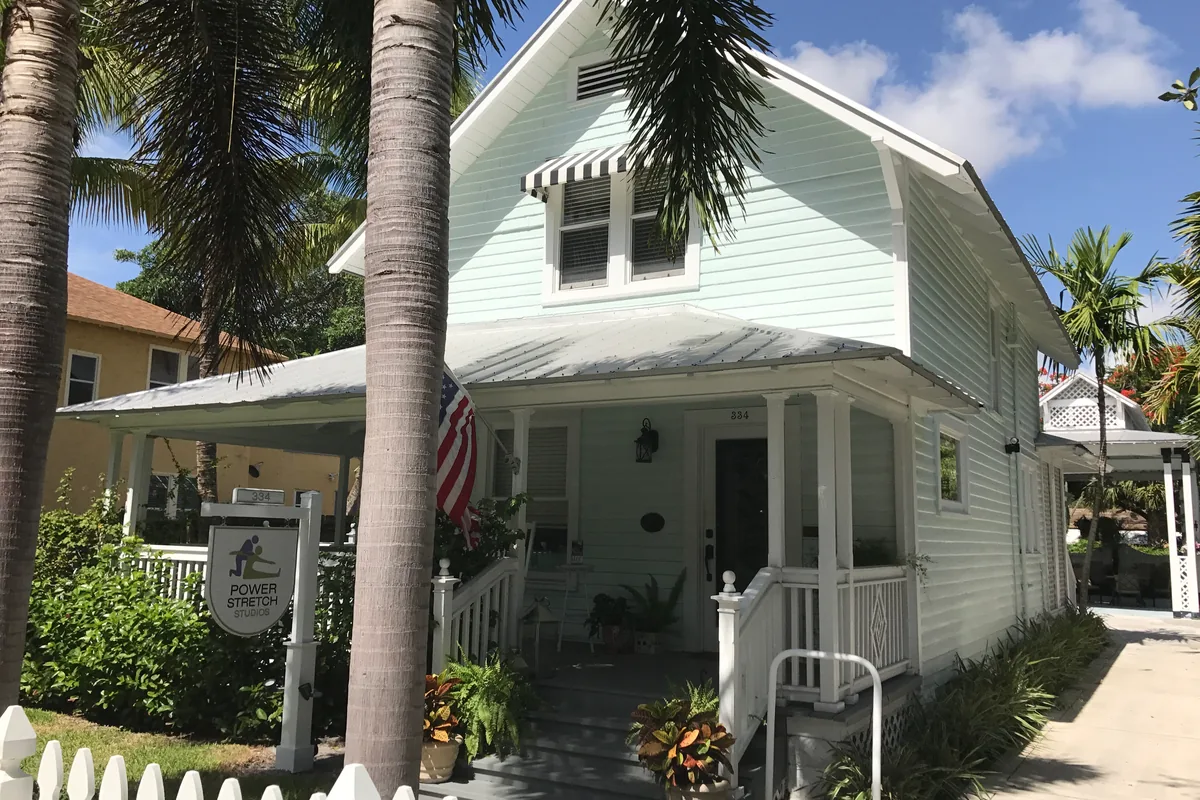 Historic house with a porch and palms in Delray Beach, Florida